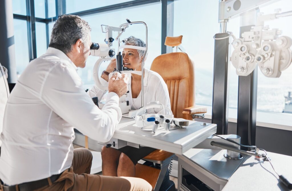 An optometrist evaluates their patient's ocular health using a slit lamp during their routine eye exam.