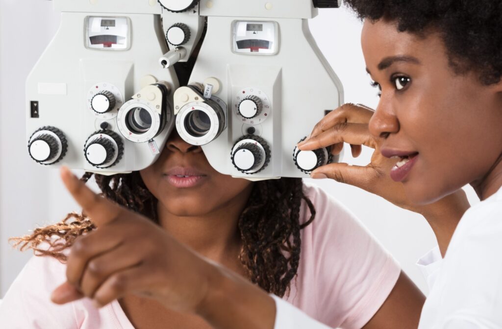 An optometrist testing the vision of a young patient.